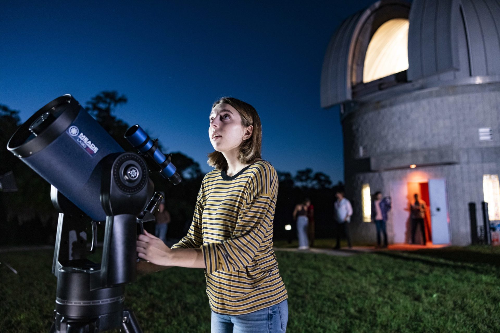 Catherine Millwater 2022 President of UCF Astronomy Society in front of the Robinson Observatory
