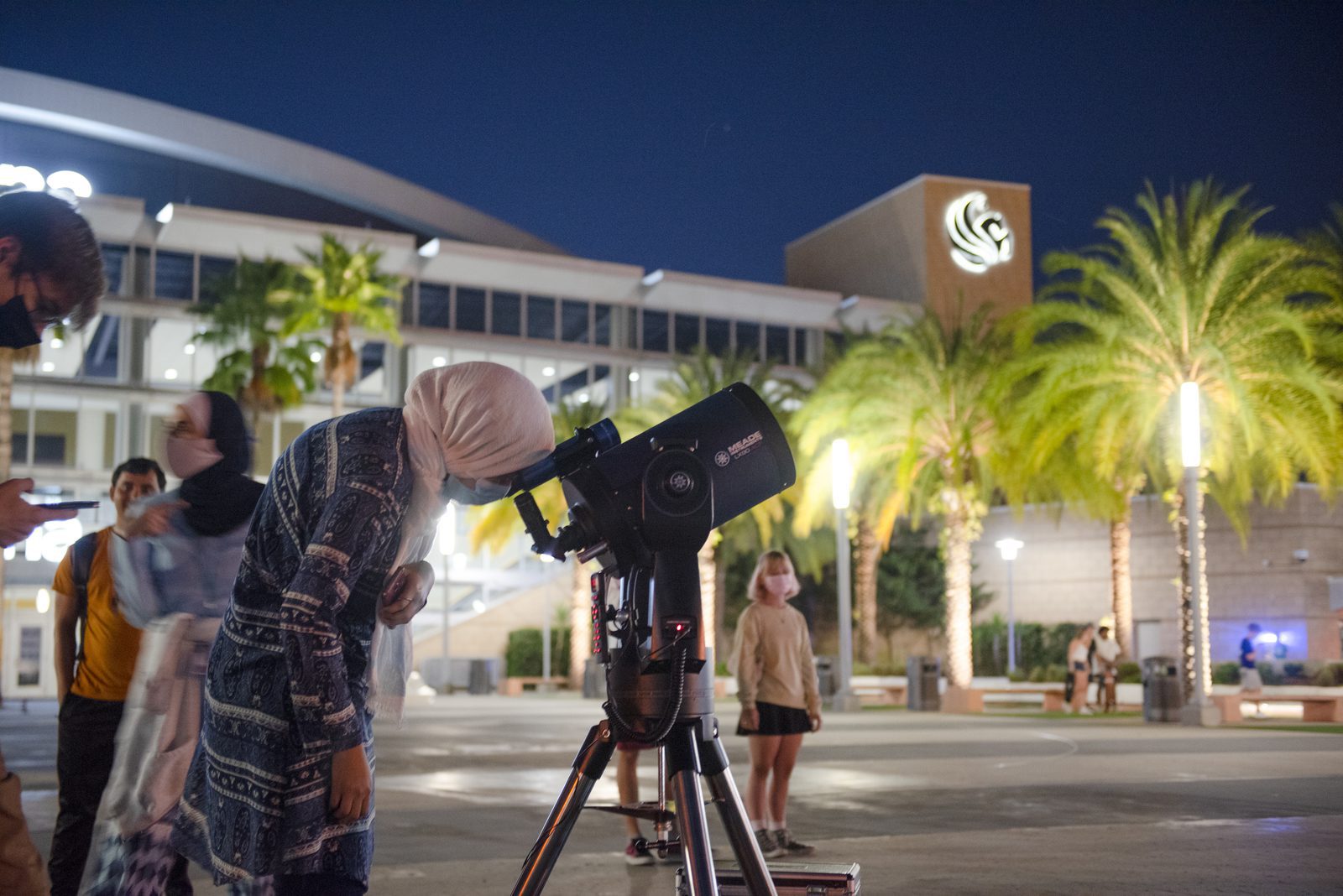 Graduate students observe the Moon at the International Observe the Moon Night event at UCF's Memory Mall