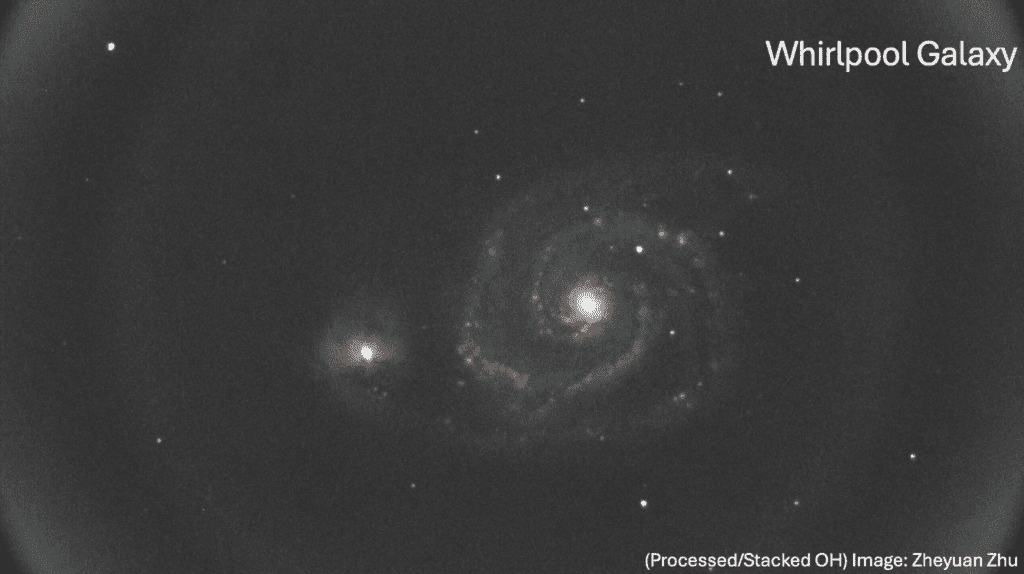 Black and white image of the Whirlpool Galaxy, showing a spiral structure with a bright core and multiple surrounding stars.